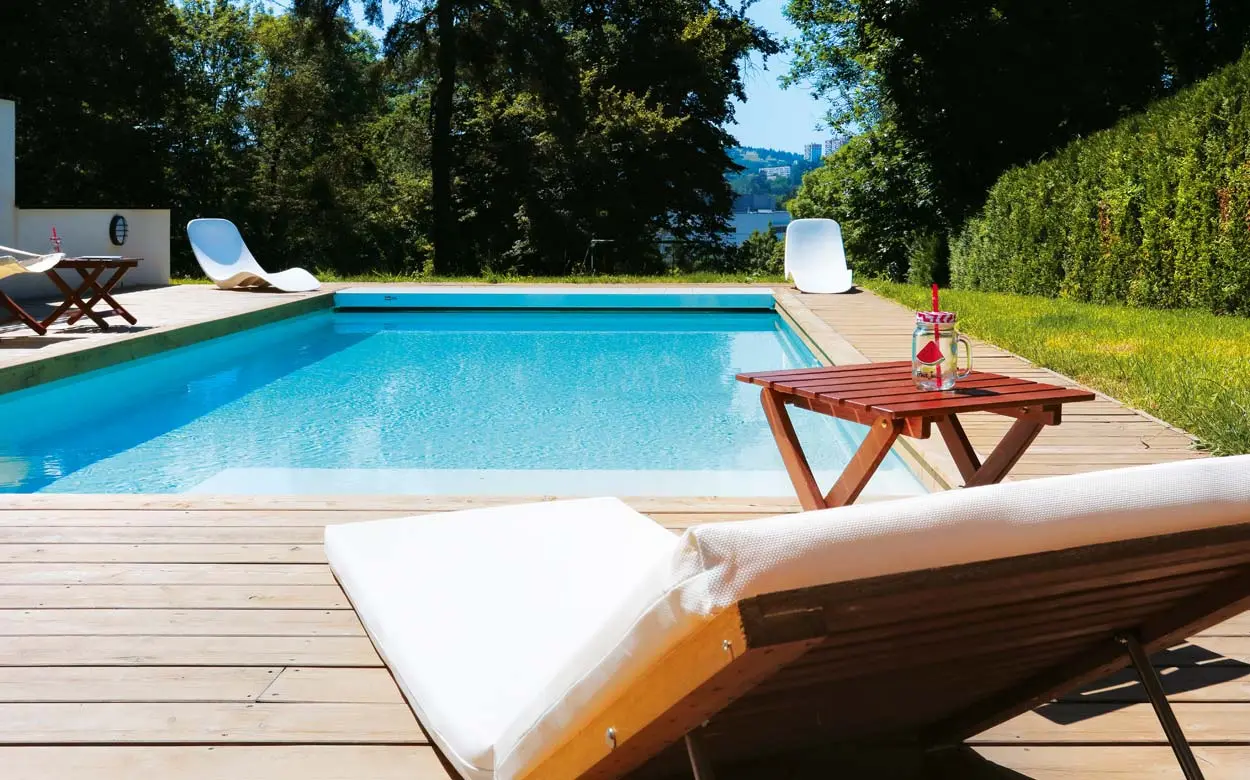 Liege am Swimmingpool im Garten